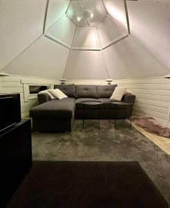 a living room with a couch and a table at Camp Caroli Hobbit Hut in Jukkasjärvi