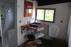 a bathroom with a sink and a shower at Bungalows de La Casona del Lago in Serranillos Playa