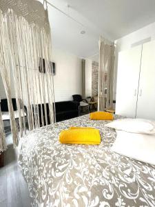 a bedroom with a bed with two yellow pillows on it at Stone Rose House in Nazaré