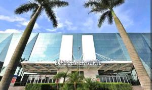 a building with palm trees in front of it at Apto em São Paulo - Expo Center, Tietê, Anhembi in Sao Paulo