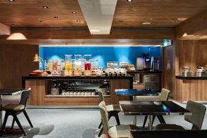 a restaurant with tables and chairs in front of a store at K Hotel Taipei Nanjing in Taipei