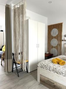 a bedroom with a bed with yellow towels on it at Stone Rose House in Nazaré