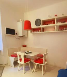 a small kitchen with a table and two chairs at Casa Xenia in Trieste