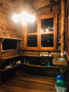 a kitchen with wooden cabinets and a sink and a light at CASA DE CAMPO in Riobamba