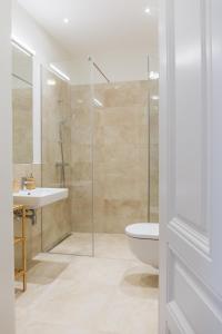 a bathroom with a shower and a toilet and a sink at Brand Cozy Apartment in Vienna