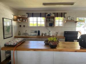 a kitchen with a wooden counter with a wooden table at Bekkersvlei - Die Huis in Haenertsburg +13 photos