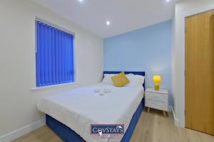 a bedroom with a large bed and a window at Beauchamp House - Apartment in Coventry City Centre, Sleeps 4, Free secure parking, by CovStays in Coventry
