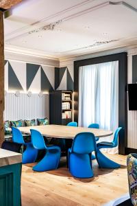a conference room with a table and blue chairs at BILBAO DREAMS Luxury in Bilbao