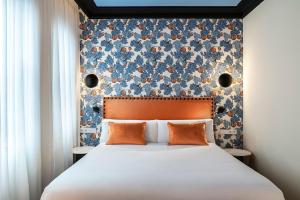 a bedroom with a large bed with a floral wall at BILBAO DREAMS Luxury in Bilbao
