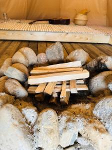 a pile of wood and rocks on a floor at Briedžio sapnas in Sudervė
