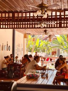 um grupo de pessoas sentadas numa mesa num restaurante em The Jam em Luang Prabang