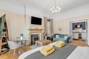 a bedroom with a bed and a living room at Brooklyn Villa in Norwich