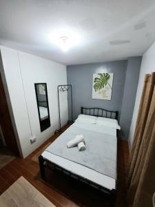a bedroom with a large bed with two pillows on it at Studio type unit - Host Homes Apitong in Tacloban