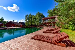 a group of benches sitting next to a swimming pool at Aerodream Trakai in Antakalnis