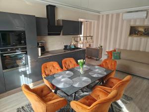 a living room with a dining room table and chairs at Várda-Lak in Kisvárda