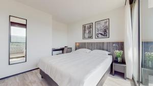Postel nebo postele na pokoji v ubytování THREE POINT Apartments