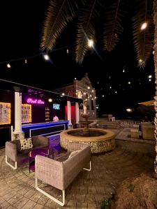 a patio with a fountain with couches and a table at Je t'aime cafe & villa in Sing Buri