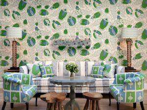 a living room with a couch and a table with chairs at Haymarket Hotel, Firmdale Hotels in London