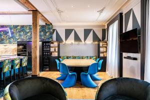 a dining room with a table and blue chairs at BILBAO DREAMS Luxury in Bilbao