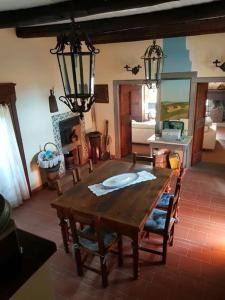 a living room with a wooden table and chairs at il salotto dei calanchi in Civita di Bagnoregio +23 photos