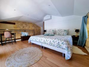 a bedroom with a large bed and a rug at Chateau Erigoye in Beychac-et-Caillau