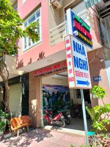 a building with a sign in front of a store at Nhà Nghỉ KHÁNH NGỌC in Vung Tau