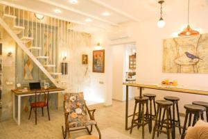 a living room with a bar and stools at LHL Old City in Batumi
