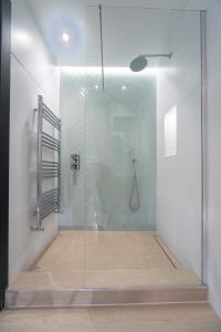 a shower with a glass door in a bathroom at Bright & Quiet - Spacious Apt with Balcony & Lift in London