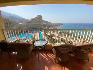 a balcony with a view of the ocean and a resort at Porto Elsokhna pyramids Family in Ain Sokhna