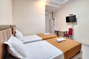 Postel nebo postele na pokoji v ubytování Hotel Jelita Mentawai Redpartner