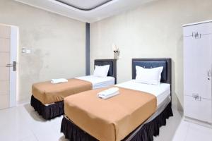 Postel nebo postele na pokoji v ubytování Hotel Jelita Mentawai Redpartner