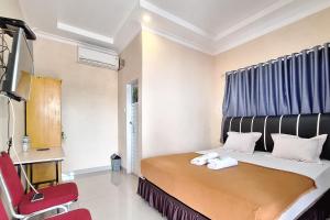 Postel nebo postele na pokoji v ubytování Hotel Jelita Mentawai Redpartner + 9 fotografií