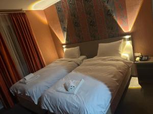 Postel nebo postele na pokoji v ubytování Park Hotel Imeri kutaisi
