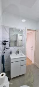 a bathroom with a white sink and a toilet at Bella Vista 414-Ocean Lanzamar- Puerto Del Carmen in Tías