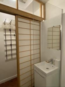 a bathroom with a toilet and a sink and a mirror at Marais Studio with Mezzanine in Paris