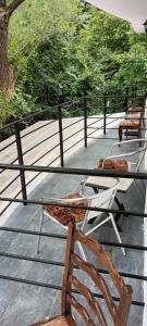 a glass table with two chairs on a patio at Pensiunea Vila Geany SRL in Băile Herculane
