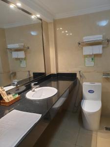 a bathroom with a sink and a toilet and a mirror at Ngọc Lan Hotel in Ho Chi Minh City