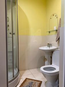 a bathroom with a toilet and a sink and a shower at Hotel Verona in Novokuznetsk