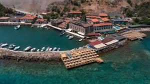 an aerial view of a harbor with boats in the water at ASSOS TROY PORT HOTEL (+8) in Ayvacık