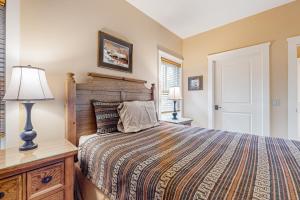 a bedroom with a bed and a lamp and a window at A1 at Castle Hill in Cavendish