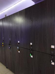 a row of brown lockers in a room at Crypto Hostel in Almaty