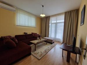 a living room with a couch and a table at Apartment Studenac in Banja Luka
