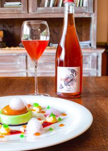 a plate of food next to a bottle of wine at KABAJ Wine & Dine in Dobrovo