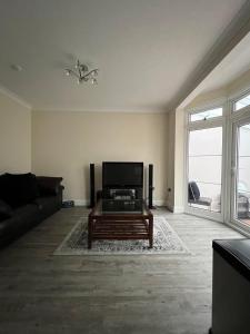 a living room with a couch and a coffee table at 4 Bedroom holiday home in Woodford