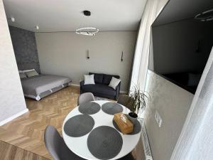 a living room with a table and a couch at Apartment 2, Podillya, новобудова in Vinnytsya