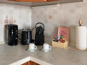 eine Küchentheke mit zwei Tassen und einer Kaffeemaschine in der Unterkunft Casa Savina - stupenda vista lago e monti in Plesio