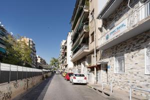 a street with cars parked on the side of a building at Kazi Home 3 in Athens