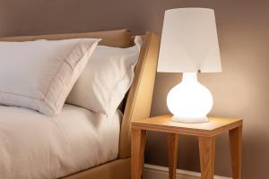 lampa na stoliku nocnym obok łóżka w obiekcie BSJ15-Borgo San Jacopo Room we Florencji