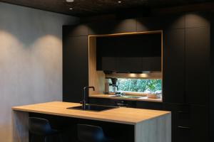 cocina con fregadero y espejo grande en Luxury Villa Lapland, en Rovaniemi
