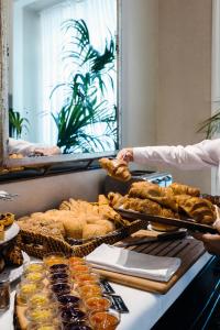 a buffet with many different types of bread and pastries at Alegria A Lisbon Boutique Hotel in Lisbon